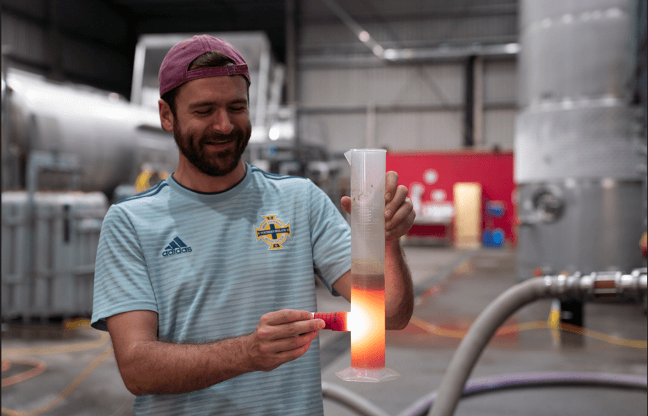 Links Winery team member inspecting wine density in a measuring cylinder during Hawke’s Bay wine making and contract wine making for Sauvignon Blanc and Pinot Gris.